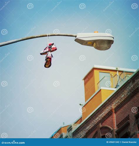 sneaker hanging on lamp pole.